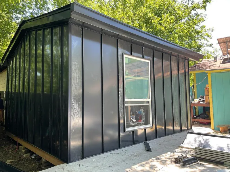 Black standing seam metal wall panels for Roof Inspection in Austin