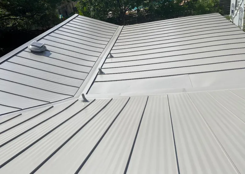 Solar attic fan installed on a metal roof for Roof Ventilation in Austin